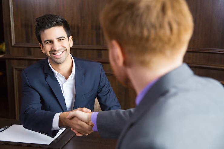 Maritime compliance consultant shaking hands with a yacht owner