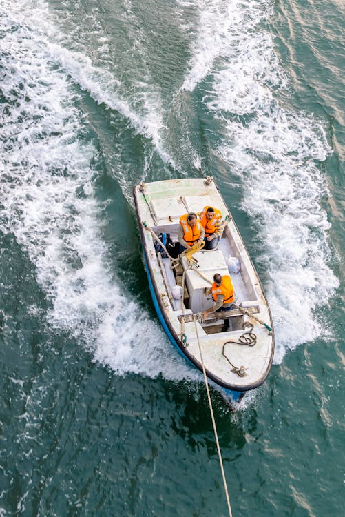 birds eye view of people in a boat being towed after an accident