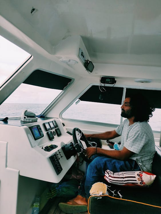 a man driving a motorboat with digital controls