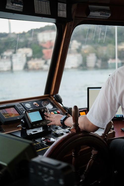 close-up of a captain using digital controls in a boat
