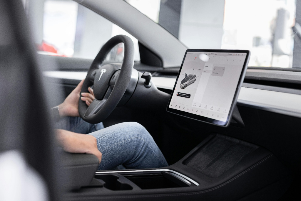 a person sitting by steering wheel